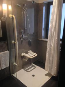 a bathroom with a shower with a glass door at Mercure Palermo Centro in Palermo