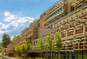 an apartment building with trees on the side of it at Waldhotel by Bürgenstock in Bürgenstock