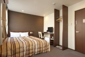 Postel nebo postele na pokoji v ubytování Hotel Kudou Oita