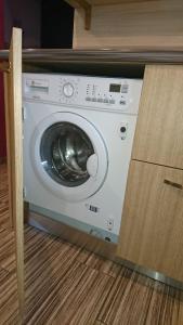 a washing machine in a cabinet in a kitchen at Holiday Home Noras Nams in Cēsis
