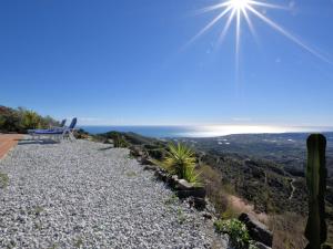 a rock pathway with a view of the ocean at Belvilla by OYO Vista Maravilla in Arenas