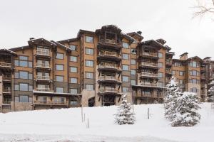 a large building in the snow with trees in front at Silver Strike #702 - 1 Bed in Park City