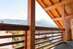a view from the balcony of a wooden house at Gapartments in Garmisch-Partenkirchen