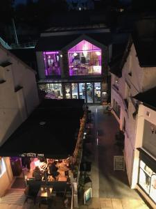 an overhead view of a restaurant with tables and purple lights at No 3 Victoria Apartment in Bowness-on-Windermere