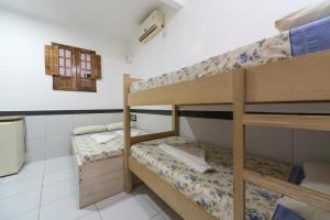 a room with two bunk beds and a window at Hotel Pousada da Praia in Recife