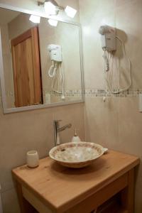 a bathroom with a sink and a mirror at ALEHUE Casa de Montaña in Villa La Angostura