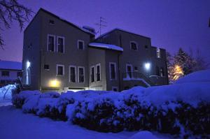 a small house with a snow covered roof at R&B Il Parco in Assergi