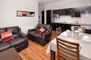 a living room with a couch and a table and chairs at Apartment 705 Letterfrack in Letterfrack