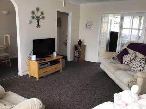 a living room with a couch and a television at 9 Gunfleet court in Clacton-on-Sea