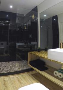 a bathroom with a sink and a large mirror at 205 New Cumberland in Cape Town