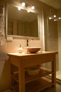 a bathroom with a sink and a mirror at ALEHUE Casa de Montaña in Villa La Angostura