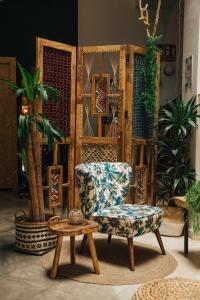 a living room filled with furniture and plants at The Urban Jungle Hostel in Málaga
