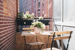 a table with potted plants on a balcony at Garai Apartment by People Rentals in Bilbao
