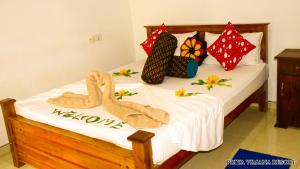 A bed or beds in a room at Priyavimana resort