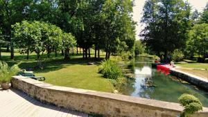 a view of a river with boats in a park at Domaine Moulin la Place in Saint-Martin-de-Saint-Maixent