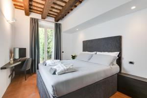 a bedroom with a large bed and a desk at Corte livia Room & Breakfast in Forlì