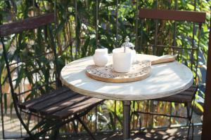 a table with two cups and a candle on it at Junior Suite The Backyard TBY 01 in Trier