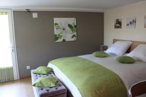 a bedroom with two beds with green pillows at Chambre d'hotes Antony in Fresnes