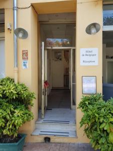 a building with a sign that reads first beehive reception at Hotel De Belgique à Menton in Menton