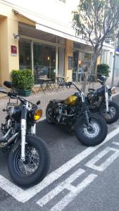 a couple of motorcycles parked in a parking lot at Hotel De Belgique à Menton in Menton