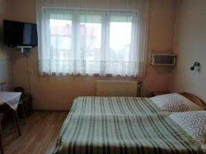 Postel nebo postele na pokoji v ubytování Pokoje PETRA pod Bocianem