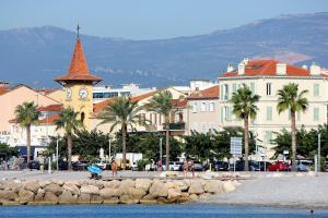 eine Stadt mit einem Uhrturm und Palmen in der Unterkunft Belle Vue in Cros-de-Cagnes