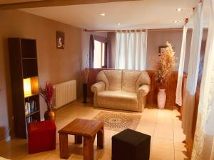 a living room with a chair and a table at Hotel Koi Mahik in El Calafate