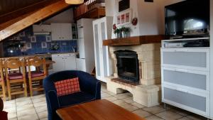 a kitchen with a living room with a fireplace at 13 Lou Veno in Les Deux Alpes +24 photos