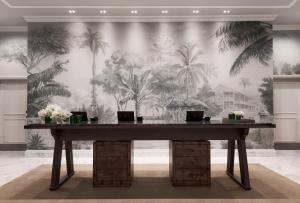 a large table in a room with a wall with palm trees at Rosewood Baha Mar in Nassau +93 photos