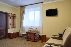 トムスクにあるHotel Extraのリビングルーム(テレビ、窓付)