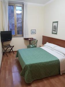 Postel nebo postele na pokoji v ubytování Hotel Duomo
