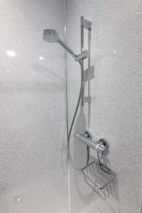 a shower with a shower head in a bathroom at Mapleview Bed and Breakfast in Corse