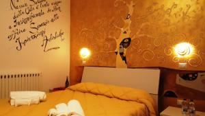 a bedroom with a bed with writing on the wall at La Dimora Degli Artisti in Catanzaro