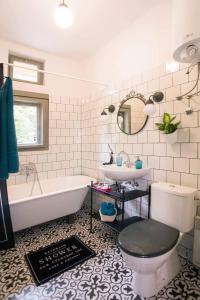 a bathroom with a tub and a toilet and a sink at Flamingos Apartment ★ Free Parking ★ City Center ★ in Novi Sad