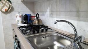 a kitchen with a sink and a stove at Casa Nax in Terni