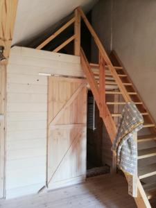 a ladder leading up to a barn door in a house at Dwór Łumbie in Sejny