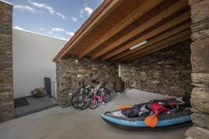 a room with a kayak and bicycles in a building at Longra Family Villa & SPA in Barcel