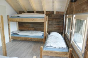 a room with two bunk beds in a cabin at L'hôtât di loup in Courtedoux