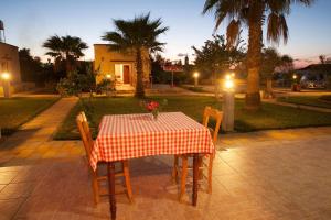 a table with a red and white checkered table cloth at Glaro Garden Hotel in Rizokarpaso