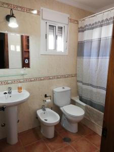 a bathroom with a toilet and a sink at CASA HACIENDA EL OLIVAR in El Bosque