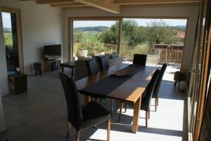 a dining room with a table and chairs at L'hôtât di loup in Courtedoux