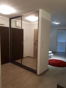 a glass door in a room with a bedroom at Wielicka Apartment in Kraków