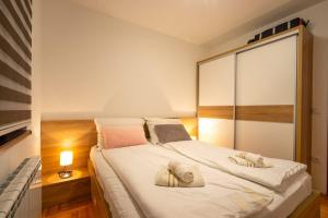 a bedroom with a bed with two pillows on it at S&M Apartmani Zlatibor in Zlatibor