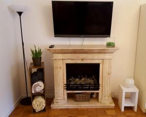 a fireplace with a television on top of it at Mountain View Apartment in Garmisch-Partenkirchen