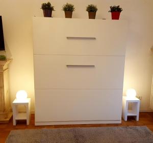 a white dresser with two lights on top of it at Mountain View Apartment in Garmisch-Partenkirchen