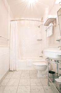 a bathroom with a toilet, sink, and shower at Hotel DeLuxe, a Provenance Hotel in Portland