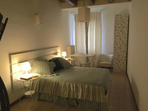 - une chambre avec un lit et une table avec deux lampes dans l'établissement Casa Mamò (Cesena Centro), à Cesena