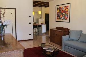 a living room with a couch and a table at Casa Mamò (Cesena Centro) in Cesena