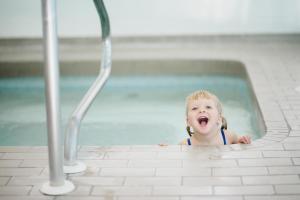 a young child in a swimming pool at Beach Acres Resort in Parksville