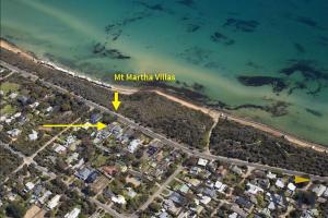 an aerial view of a beach with a large body of water at Mt Martha Villas in Mount Martha